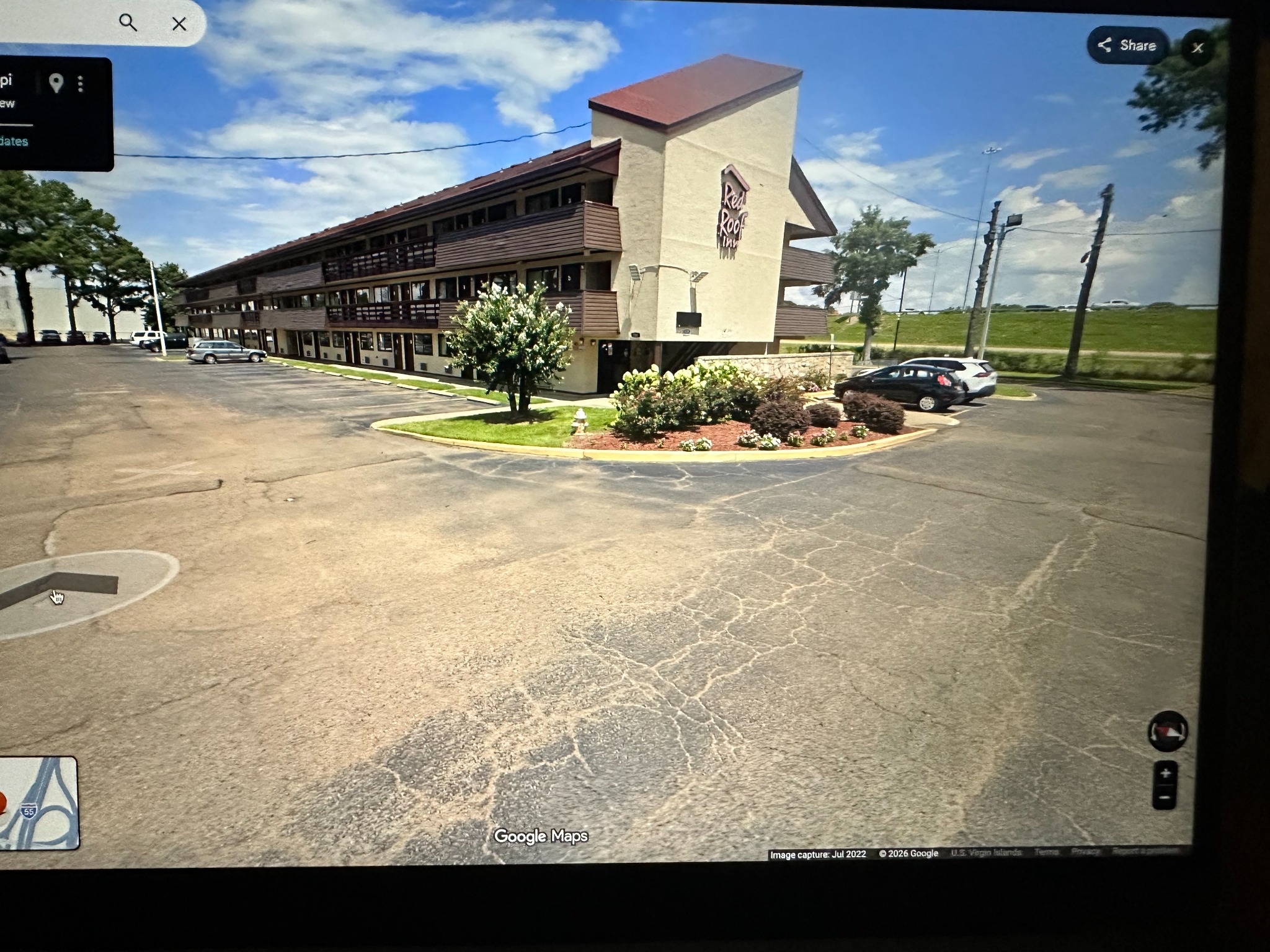 Red Roof Inn entrance and parking area viewed from the other side of the hotel